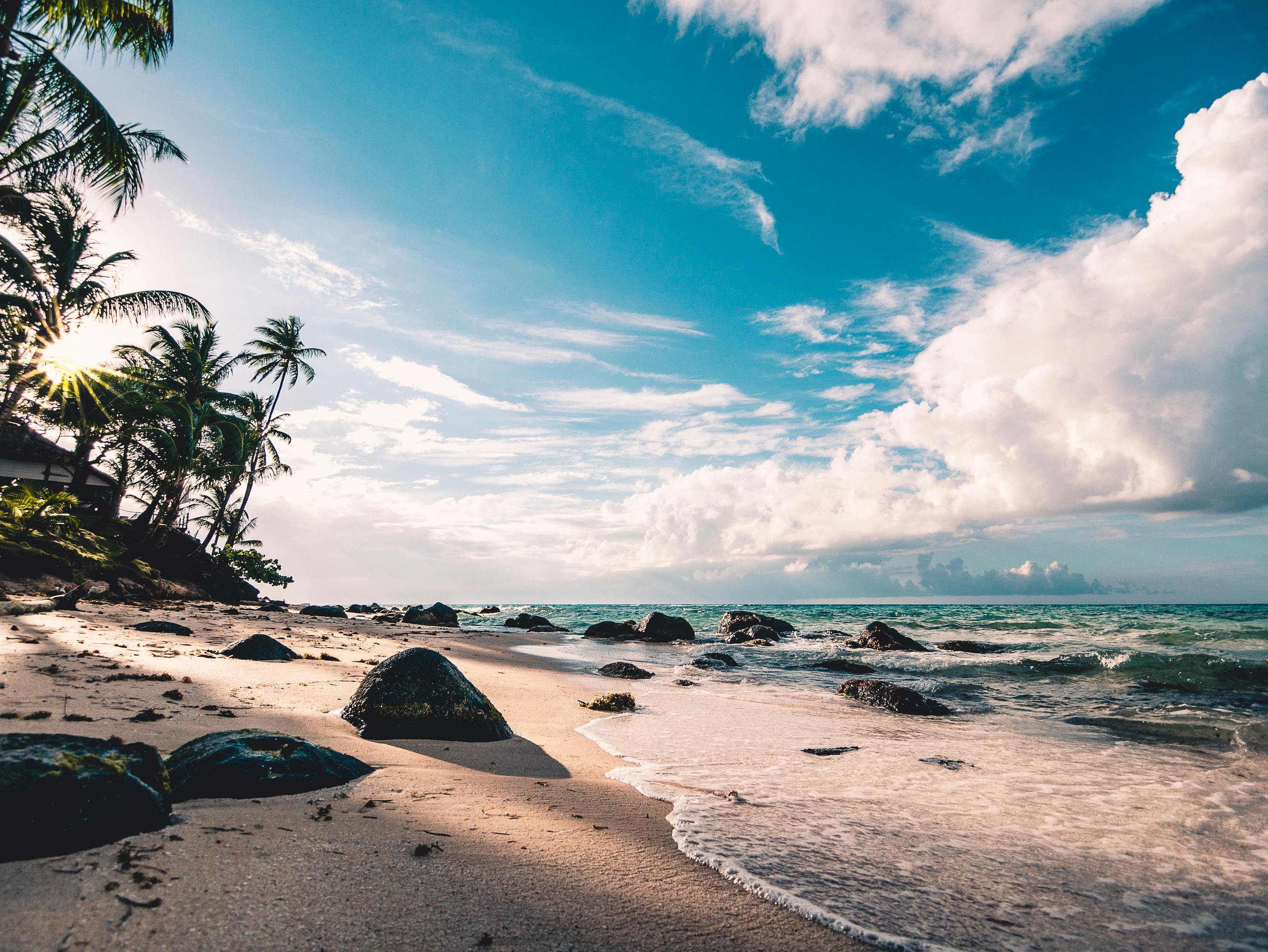 Sunny beach scene with clear sea water and sand, illustrating the marine environment linked to seawater skin‑care benefits